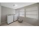 Well-lit laundry room with a washer, dryer, and natural light from two windows at 4783 School Rd, Land O Lakes, FL 34638