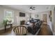 Inviting living room features a fireplace, ceiling fan, and dark leather sofas at 4783 School Rd, Land O Lakes, FL 34638