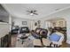 Cozy living room featuring wood floors, leather sofas, and an open archway to the dining area at 4783 School Rd, Land O Lakes, FL 34638