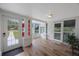 Bright sunroom with hardwood floors, white walls, and a view of the front yard, creating a welcoming ambiance at 4783 School Rd, Land O Lakes, FL 34638
