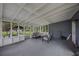 Screened-in porch offering an inviting seating area and an outdoor view of the backyard at 4783 School Rd, Land O Lakes, FL 34638