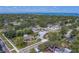 A view overlooking a home in a lush neighborhood with mature trees and clear views of the ocean at 501 Poinsettia Rd, Belleair, FL 33756