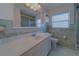 Bathroom with long vanity, tile, and shower with glass door at 501 Poinsettia Rd, Belleair, FL 33756