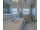 Well-lit bathroom featuring a single sink vanity and a glass-enclosed shower at 501 Poinsettia Rd, Belleair, FL 33756