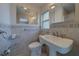Bathroom with tile floors, pedestal sink, and vanity mirror at 501 Poinsettia Rd, Belleair, FL 33756