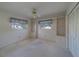 Bright bedroom with built-in bookshelves, closet, and carpeted floor at 501 Poinsettia Rd, Belleair, FL 33756