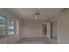 Bedroom with carpet floor, ceiling fan, built in bookshelves, and mirrored closet at 501 Poinsettia Rd, Belleair, FL 33756