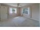 Cozy bedroom features carpet floors, natural light from two windows, and a spacious closet at 501 Poinsettia Rd, Belleair, FL 33756