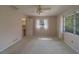 Bright bedroom with carpet flooring, ceiling fan, and attached ensuite bathroom for added convenience at 501 Poinsettia Rd, Belleair, FL 33756