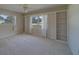 Bright bedroom boasts carpet floors, built-in bookshelves, and natural light streaming through the windows at 501 Poinsettia Rd, Belleair, FL 33756