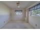 Cozy bedroom featuring a ceiling fan and natural light from a window at 501 Poinsettia Rd, Belleair, FL 33756