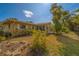 Single-story home surrounded by lush landscaping, a sunroom and views of the property at 501 Poinsettia Rd, Belleair, FL 33756