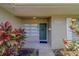 Close-up of the front entrance with a well-decorated door and vibrant tropical plants at 501 Poinsettia Rd, Belleair, FL 33756