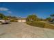 Charming single-story home featuring a spacious driveway, two-car garage and lush tropical landscaping at 501 Poinsettia Rd, Belleair, FL 33756