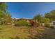Front yard showcasing a well-manicured lawn and lush, mature landscaping at 501 Poinsettia Rd, Belleair, FL 33756