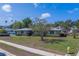 Charming home with a well-manicured front yard and mature trees at 501 Poinsettia Rd, Belleair, FL 33756