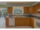 Well-lit kitchen showcasing wooden cabinets, countertops, and appliances at 501 Poinsettia Rd, Belleair, FL 33756