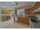 Charming kitchen features wooden cabinets, tile flooring, and a built-in beverage cooler at 501 Poinsettia Rd, Belleair, FL 33756