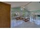 Sunroom with vaulted ceilings, tile flooring, and an open view of the exterior at 501 Poinsettia Rd, Belleair, FL 33756