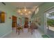 Bright living room featuring vaulted ceilings, white tile floors, large windows, and comfortable seating at 501 Poinsettia Rd, Belleair, FL 33756