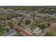 Aerial view of home with brick streets, lush trees, and a mix of residential and commercial buildings at 504 Cleveland Ave, Largo, FL 33770