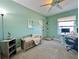 Light-filled bedroom features wood floors, a ceiling fan, and a cozy nook by the front door at 504 Cleveland Ave, Largo, FL 33770