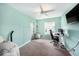Bedroom featuring carpet floors, gaming setup, and a large window with natural light at 504 Cleveland Ave, Largo, FL 33770