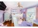 Delightful ' bedroom featuring a bunk bed with slide, wood floors, and playful decor at 504 Cleveland Ave, Largo, FL 33770