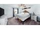 Comfortable bedroom with a large bed, ceiling fan, and a window letting in natural light at 504 Cleveland Ave, Largo, FL 33770