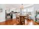 Open-concept dining area with a round table, pendant lighting, and views to the modern kitchen at 504 Cleveland Ave, Largo, FL 33770