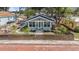 Charming single-story home featuring a quaint front porch, fenced yard, and well-maintained landscaping at 504 Cleveland Ave, Largo, FL 33770
