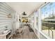 Inviting enclosed front porch with ample natural light, rocking chairs, and views of the outdoors at 504 Cleveland Ave, Largo, FL 33770
