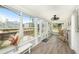 Bright and airy enclosed front porch with wood floors, white trim, and multiple windows at 504 Cleveland Ave, Largo, FL 33770