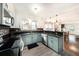 Charming kitchen boasts modern appliances, granite counters, and stylish light blue lower cabinets at 504 Cleveland Ave, Largo, FL 33770