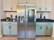 Bright kitchen features a stainless steel refrigerator and updated cabinets at 504 Cleveland Ave, Largo, FL 33770