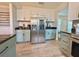 Kitchen features stainless steel refrigerator, updated cabinets, and hardwood flooring at 504 Cleveland Ave, Largo, FL 33770