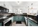 Charming kitchen boasts modern appliances, granite counters, and stylish light blue lower cabinets at 504 Cleveland Ave, Largo, FL 33770
