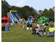 A lively park event featuring inflatable slides, activities, and people enjoying outdoor leisure at 504 Cleveland Ave, Largo, FL 33770