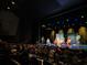 A theater space with an audience watching a performance on stage with elaborate backdrops at 504 Cleveland Ave, Largo, FL 33770