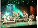 Theater stage illuminated by green lights, featuring a young cast in a high energy performance with an audience at 504 Cleveland Ave, Largo, FL 33770
