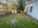 Fenced backyard with grass, storage shed, and shade trees at 5124 Chilkoot St, Tampa, FL 33617