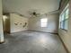 Spacious empty living room with a ceiling fan and windows, offering renovation possibilities at 5124 Chilkoot St, Tampa, FL 33617