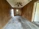 This living room features wood paneling, a ceiling fan, and plenty of space for furnishing at 5124 Chilkoot St, Tampa, FL 33617