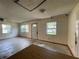 Empty living room with three windows and a door to the outside, showcasing natural light at 5124 Chilkoot St, Tampa, FL 33617