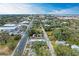 Nice aerial view of the neighborhood showing a road leading to the city with trees on either side and clear blue sky at 613 6Th E Ave, Bradenton, FL 34208