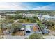 An aerial shot of a new construction home nestled amongst lush greenery in the neighborhood at 613 6Th E Ave, Bradenton, FL 34208