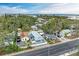 Aerial view of single Gathering home from above near the bay, with lots of trees around at 613 6Th E Ave, Bradenton, FL 34208