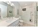 This bathroom has a white sink and quartz countertop, a toilet, and a glass enclosed shower at 613 6Th E Ave, Bradenton, FL 34208
