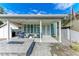 The home features a paved front yard area, a modern design and comfortable outdoor seating area at 613 6Th E Ave, Bradenton, FL 34208