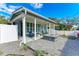 The home features a paved front yard area, a modern design and comfortable outdoor seating area at 613 6Th E Ave, Bradenton, FL 34208